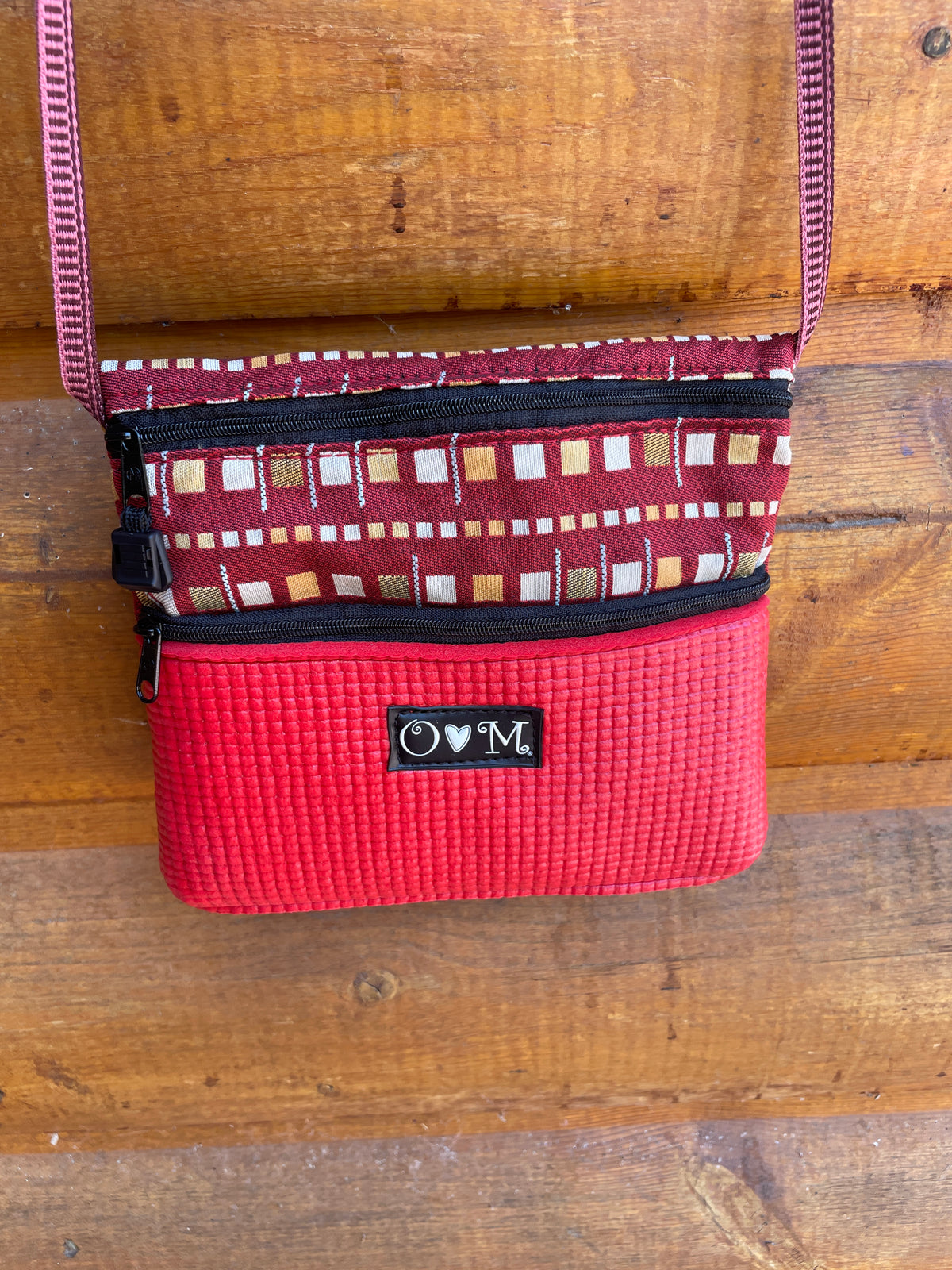 cross body small purse with 3 zipper pockets. 7.5z7 size handmade red yoga mat bottom with geometric print fabric top and the whole back.Hand Made in Colorado