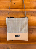 OlovesM tan with a vynl print dots fabric Stella Crossbody bag handcrafted in the USA from a tan recycled yoga mat base and upcycled fabrics. Sustainable, vegan, and water-resistant.